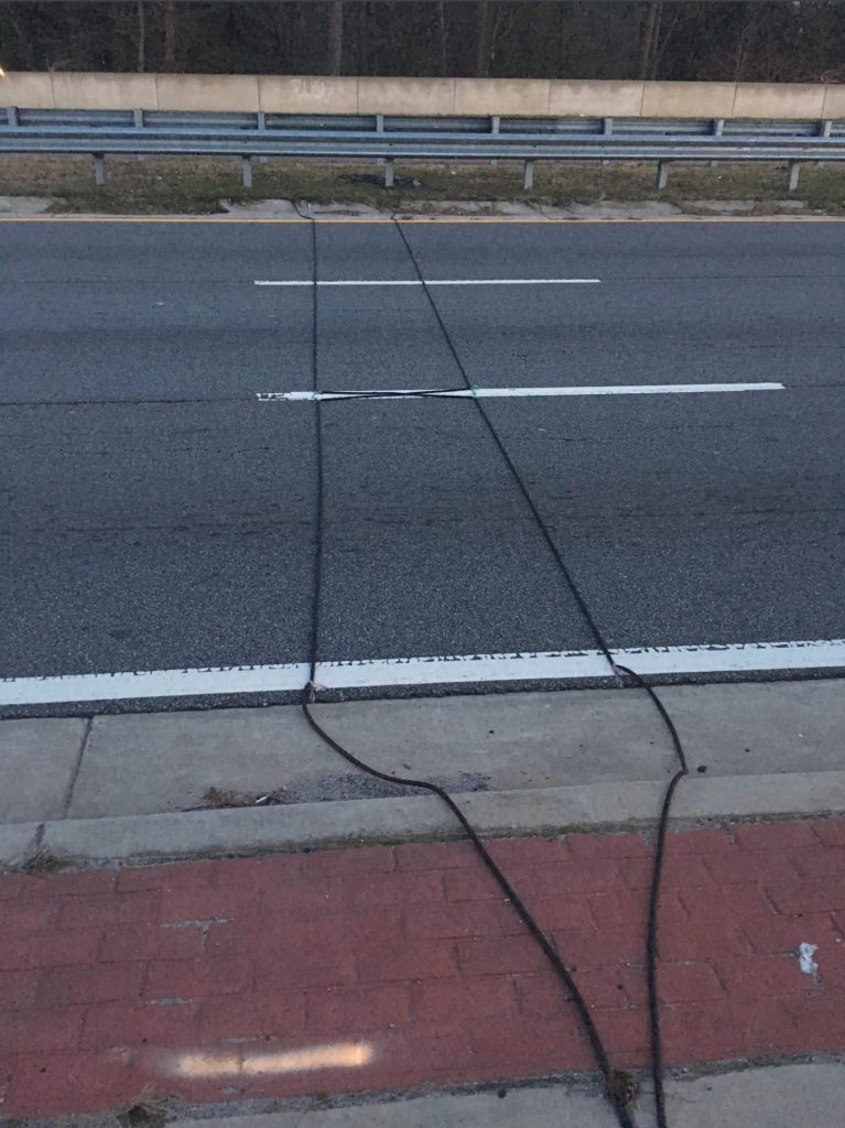 What Those Black Rubber Cables on the Road Really Do